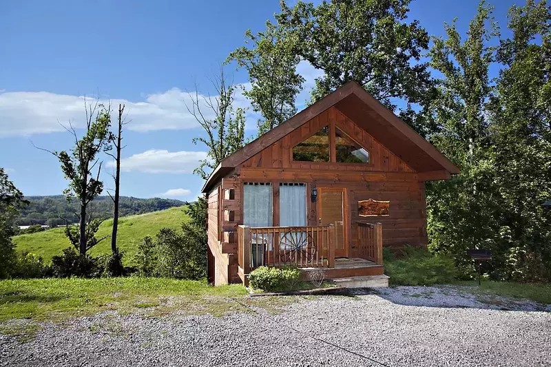 front of Saddle Up cabin with hilly views in the background