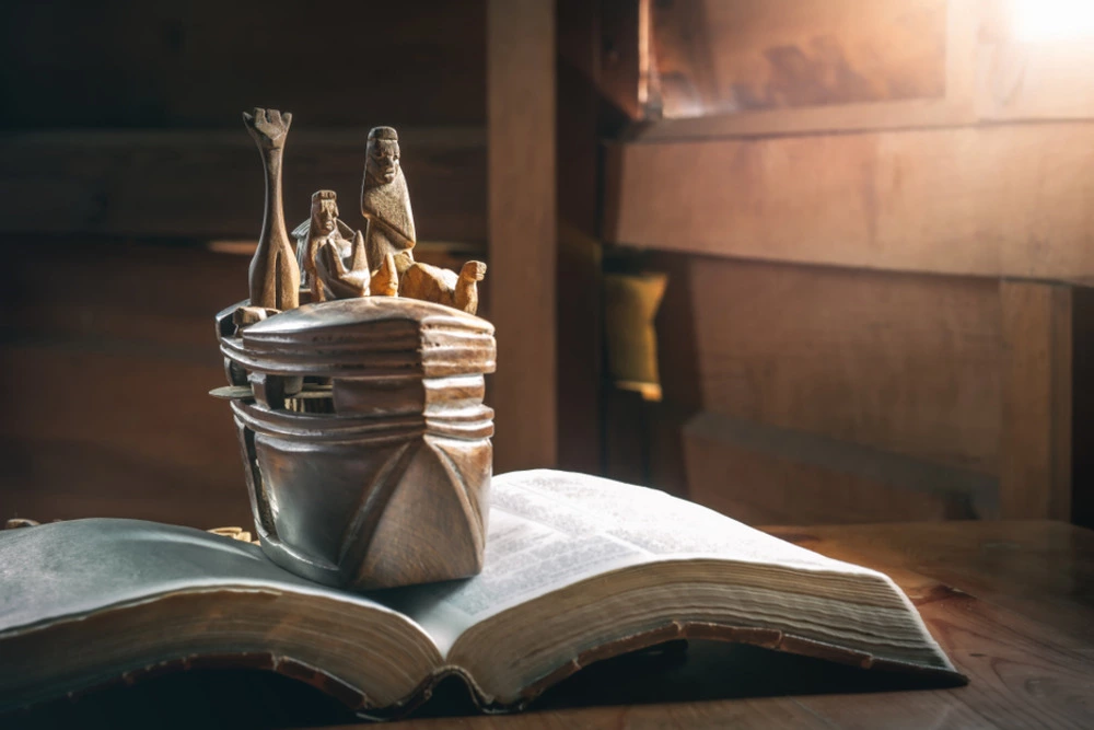 open Bible with wooden model of Noah's ark